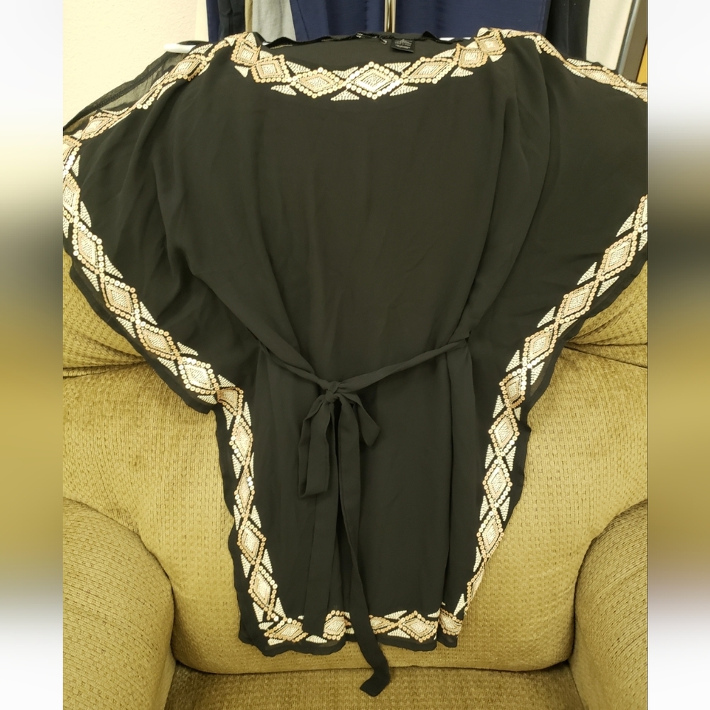 Beautiful black, short sleeve,sheer blouse with gold and silver sequined details
